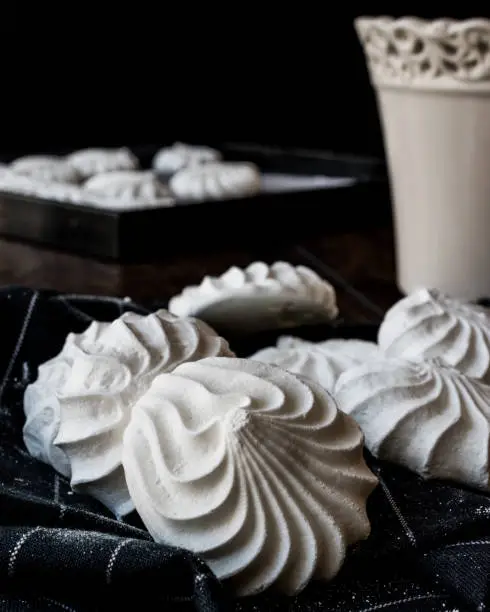 Meringue is a type of dessert, often associated with French, Swiss, and Italian cuisine, made from whipped egg whites (or aquafaba) and sugar, and occasionally an acidic ingredient such as lemon, vinegar or cream of tartar.