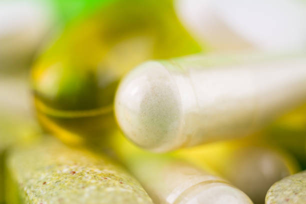 Mixed natural food supplement pills, omega 3, multivitamin and glucosamine capsules, macro image.