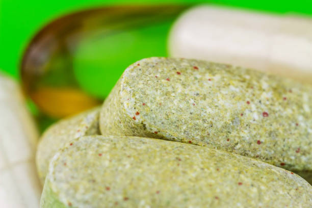 Mixed natural food supplement pills, omega 3, multivitamin and glucosamine capsules, macro image.
