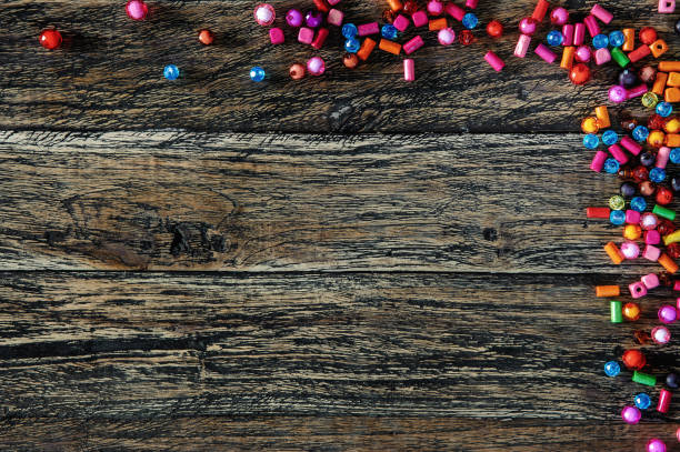 istock Colorful beads on wooden background 640925490