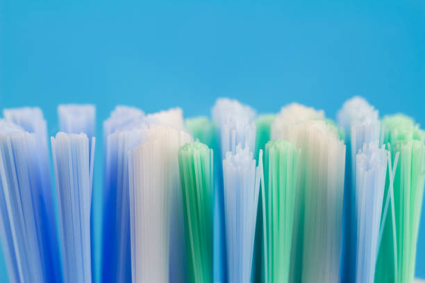 Macro photo of toothbrush isolated on blue background.
