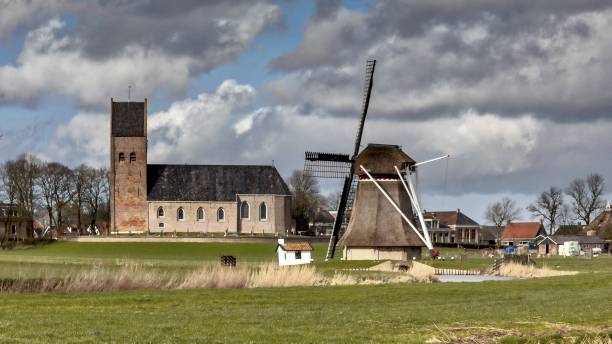 istock Village with church and historic windmill 640928486