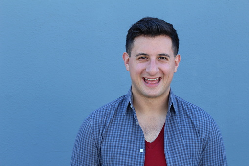 Excited guy against blue background - Stock image.