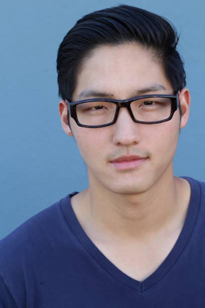 istock Asian man wearing glasses on blue background 640930790