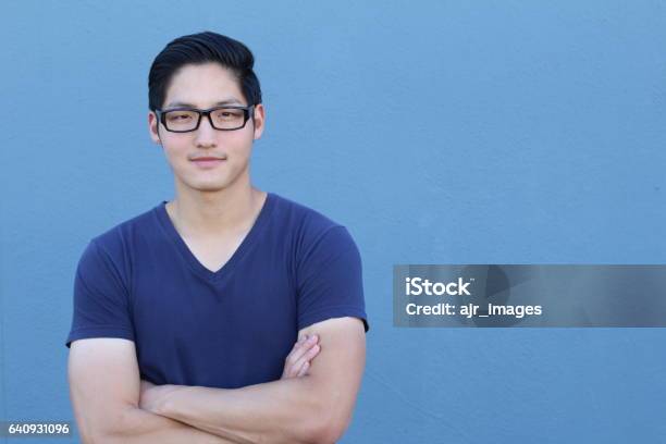 Asian Man Wearing Glasses On Blue Background Stock Photo - Download Image Now - Men, Males, University Student