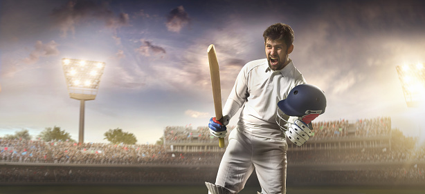 Cricket player is emotionally happy  on a cricket field. The batsman is wearing unbranded sports cloth and equipment. The bleachers full of people are blurred behind the player. There are intentional lenseflares on the image. The stadium is made in 3D.