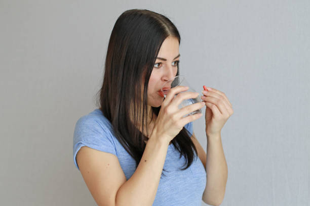 istock Woman Taking a Capsule 640931930