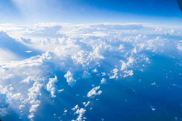 istock Clouds seen from the window of an airplane, on a blue sky background. 640934962
