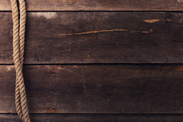 istock vintage background with old rope on wood planks 640935112