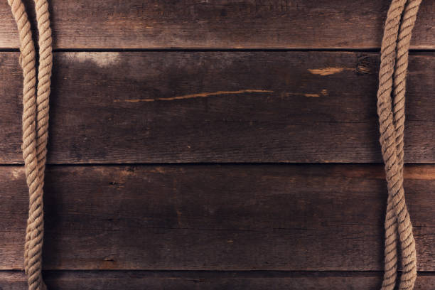 istock weathered ship ropes on old wooden plank background 640935206