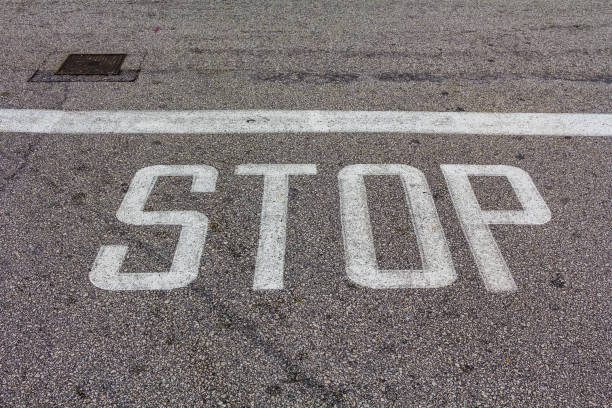 istock Word Stop written on an asphalt road, Stop Sign 640936946