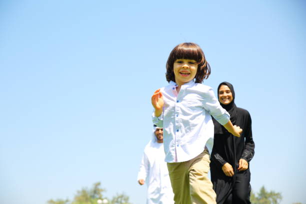 Arab Emirati family outdoors in park.