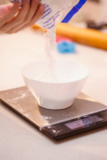 istock Weighting sugar on kitchen scales 640947546