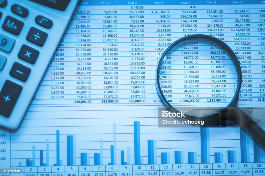 Spreadsheet bank accounts accounting with calculator and magnifying glass. Spreadsheet bank accounts accounting with calculator and magnifying glass. Concept for financial fraud investigation, audit and analysis. Accountancy Stock Photo