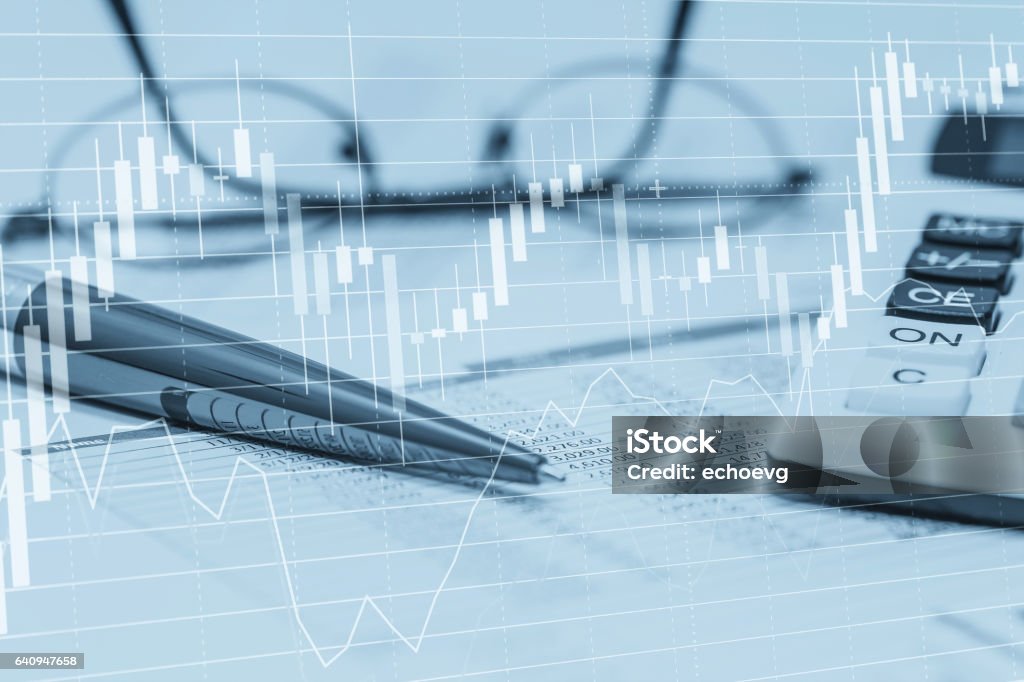 Stock data charts with spreadsheet calculator pen and glasses. Concept abstract photo of stock market financial bank accounting data analysis and monitoring. Calculator Stock Photo