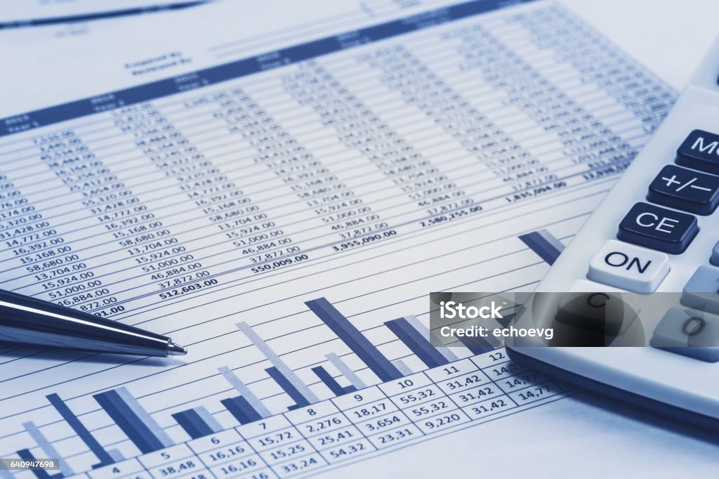 Accounting financial banking banker bank stock spreadsheet data with pen and calculator in blue analysis analyzer calculations Spreadsheet Stock Photo