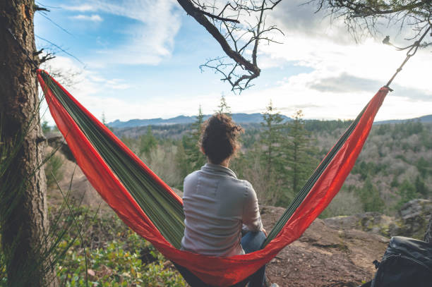 istock Young woman in hammock in forest 640948002