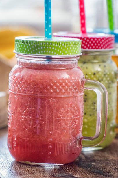 Freshly blended fruit smoothies of various colors and tastes