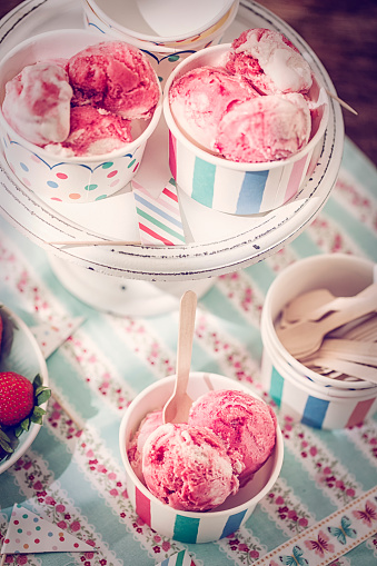 Eating homemade strawberry ice cream. This creamy delicious ice cream is a perfect treat on a sunny day.