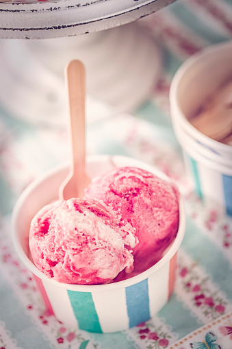 Eating homemade strawberry ice cream. This creamy delicious ice cream is a perfect treat on a sunny day.