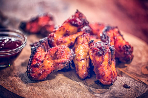 Spit Roasted Spicy Chicken Wings on a Barbecue Grill