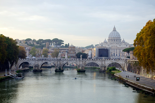 Beautiful scene in Rome, with the Tiber river and the Basilica of Saint Pietro on scene.
