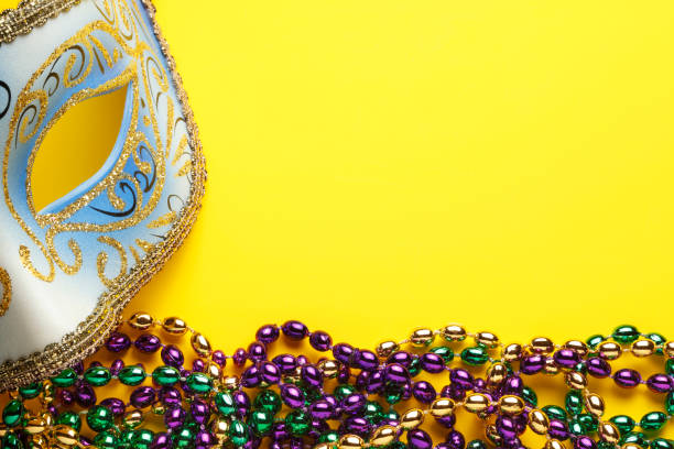 istock Carnival Mask And Mardi Gras Beads On Yellow Background 640950458