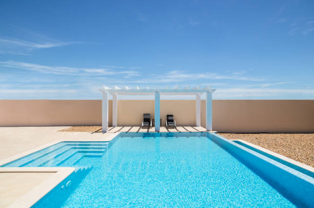 istock Poolside pergola and infinity swimming pool 640952544
