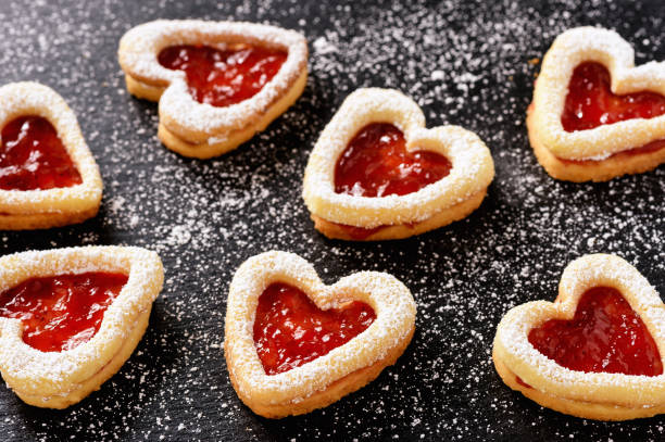istock Homemade shortbread heart cookies on black background. 640954104