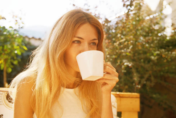 young woman drinking coffee or tea