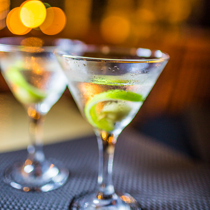 A close-up of two martinis, on a table, waiting to be savoured. Shot at night in Santo Domingo