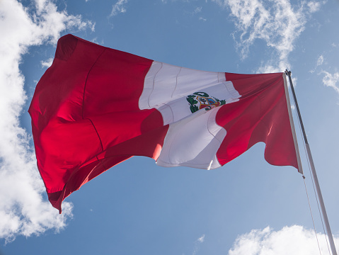 Flag of Peru waving against blue sky