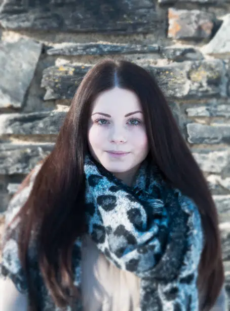 pretty young woman portrait with scarf in nature