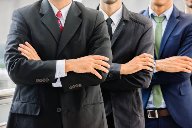 Businessmen with crossed arms outdoor. Businessmen with crossed arms outdoor.Teamwork business concept. asian suit man cross hand stock pictures, royalty-free photos & images