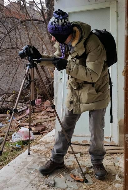 istock Photographer shooting in a ruined abandoned apartment 640975208