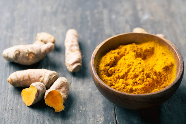 istock Spice: turmeric roots and powder on wood 640976140