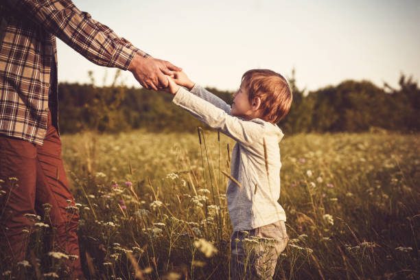 istock Father and son are playing on a field 640986114