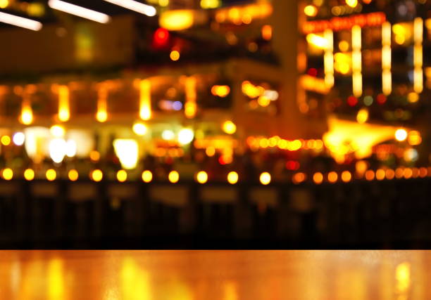 istock wood table with blur city light of bar at night 640988366