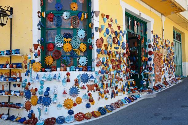 Pottery displayed on the wall of a shop in the village centre, Margarites, Crete, Greece, Europe.