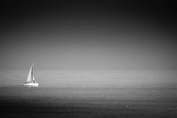 A lone yacht on the horizon at Seaton Sluice, Northumberland.