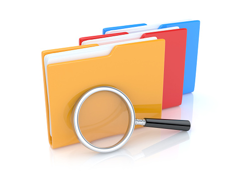 Folders with magnifier glass isolated on white background