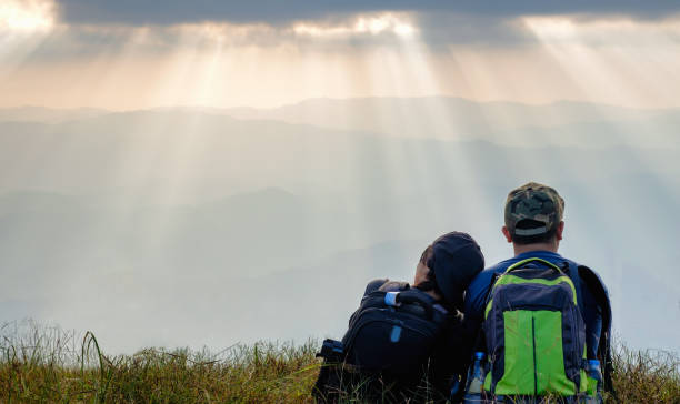istock asian couple sitting together on mountain 640998376