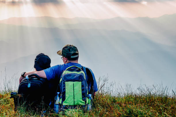 istock asian couple sitting together on mountain 640998472