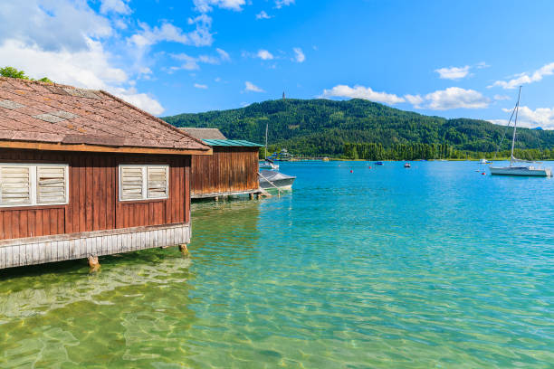 Wooden traditional boat house on shore of Worthersee lake in summer, Austria Most popular lake in Austria for summer holidays pörtschach am wörthersee stock pictures, royalty-free photos & images