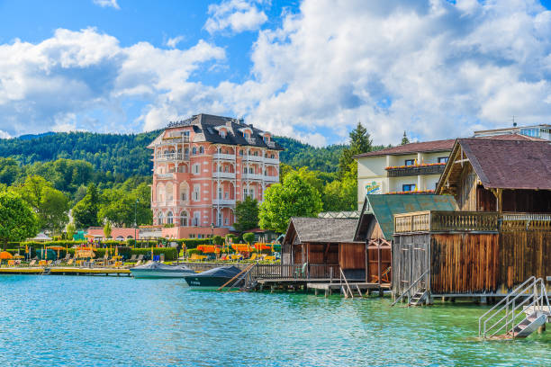 WORTHERSEE LAKE, AUSTRIA WORTHERSEE LAKE, AUSTRIA - JUN 20, 2015: luxury hotel Astoria on shore of beautiful alpine lake Worthersee in summer. pörtschach am wörthersee stock pictures, royalty-free photos & images