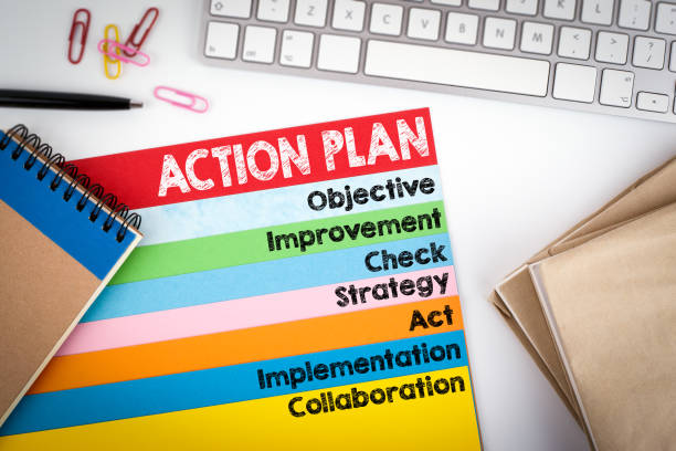 istock Action Plan. Office desk with a computer keyboard and color pages 641000360