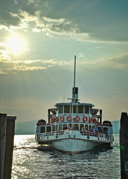 Tourists sail by ferry from the port of Bardolino, a beautiful city on Lake Garda, Italy.