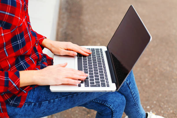 istock Woman working using laptop computer in city, hands on keyboard closeup 641006310