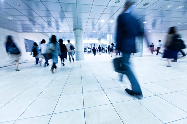 crowds of commuters walking through underground pedestrian walkway