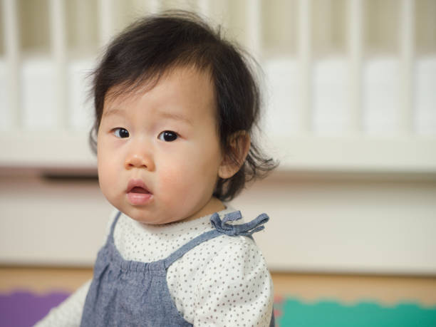 istock Baby girl with serious face 641009596